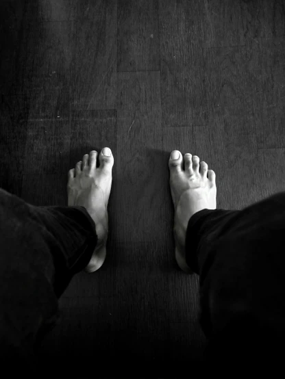 a persons feet that are standing in the floor