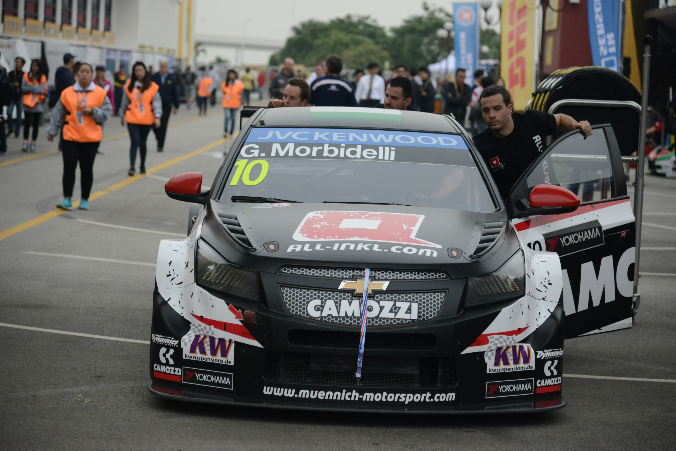 a man putting his car on the road in a race