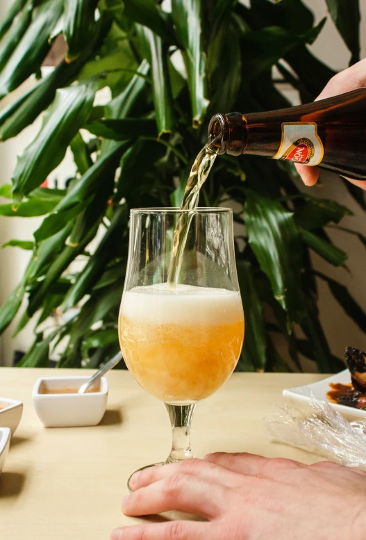 man pouring an alcoholic beverage into a glass