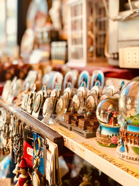 many snow globes sitting on a shelf in a store