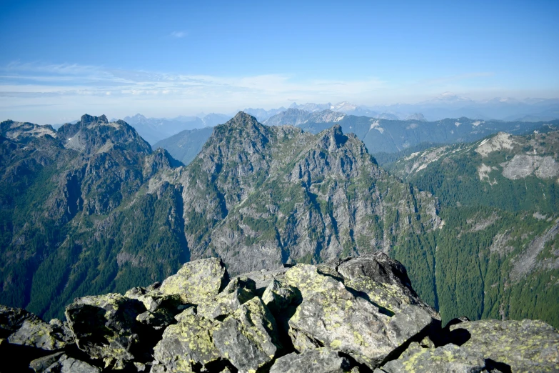 the view from a mountain peak shows the valley below