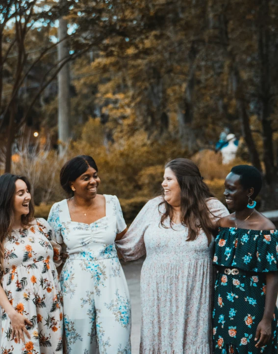 some ladies standing next to each other while talking