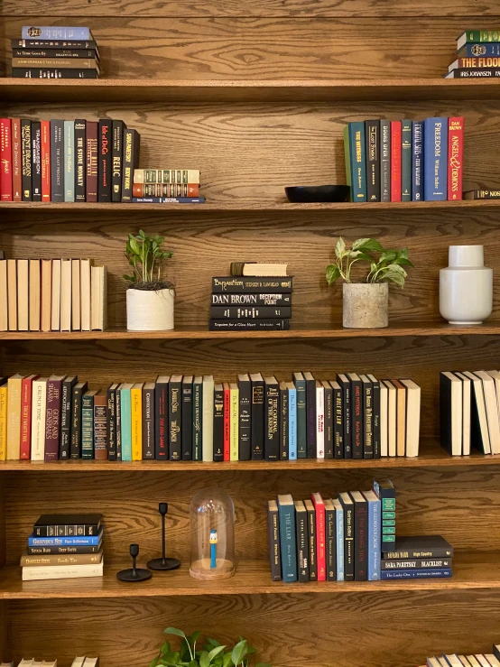 the bookshelf with many different types of books are on display