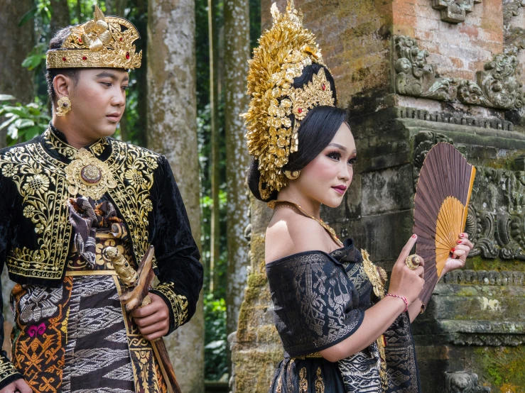 the couple are dressed in traditional thai garb