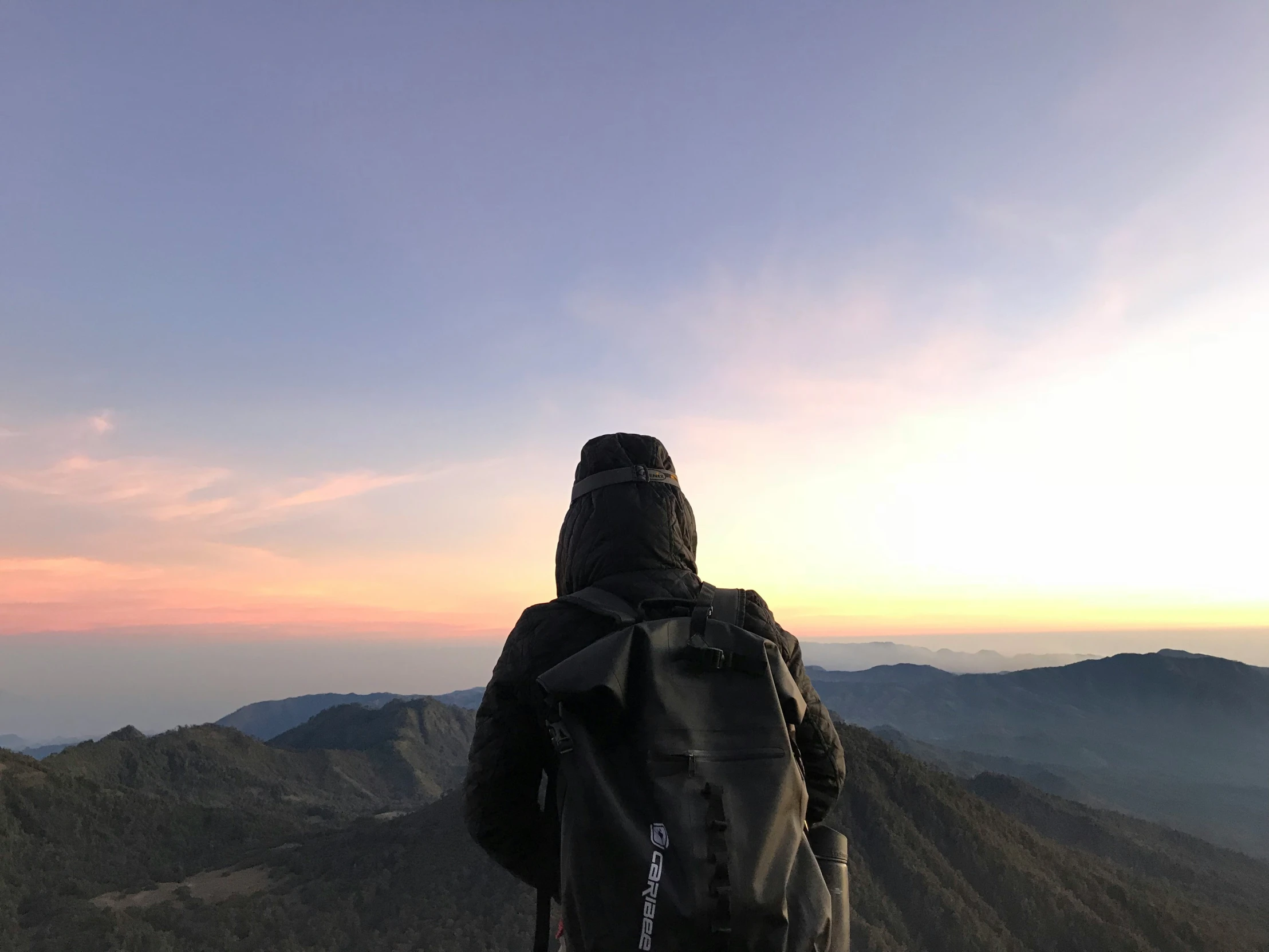 a person standing on top of a high mountain