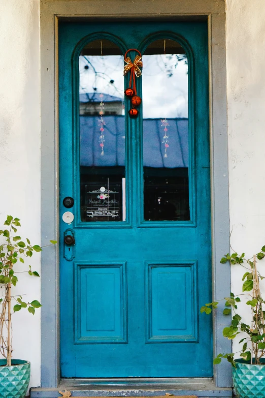 a green door has a sign on the glass