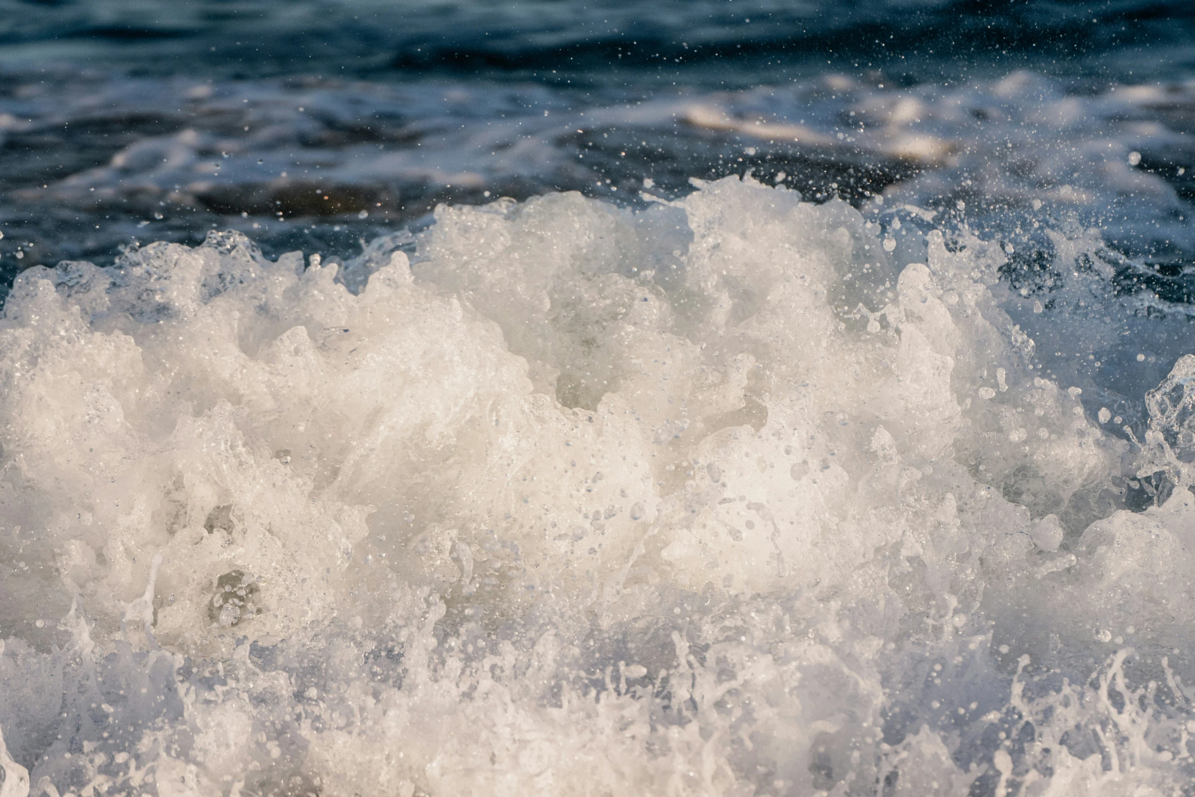 waves crash together with the shore at the end