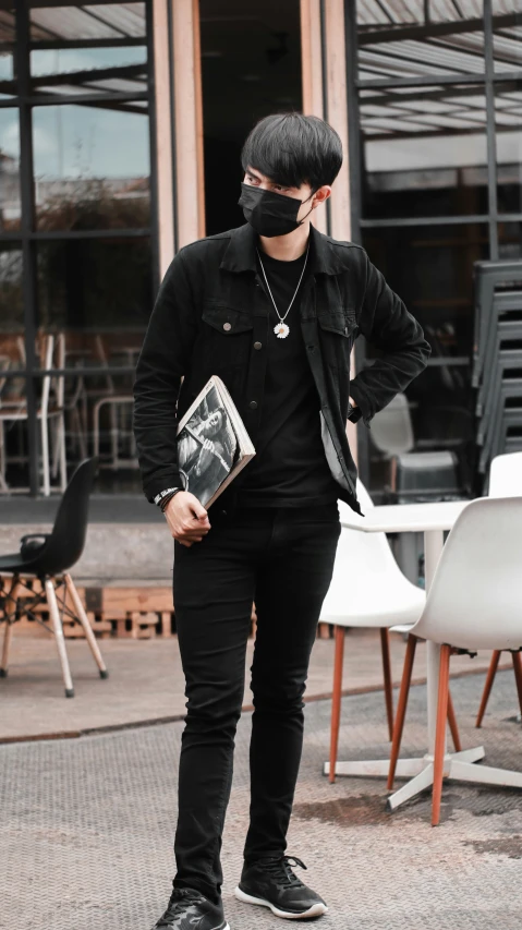 a man is wearing a blindfold and holding a purse