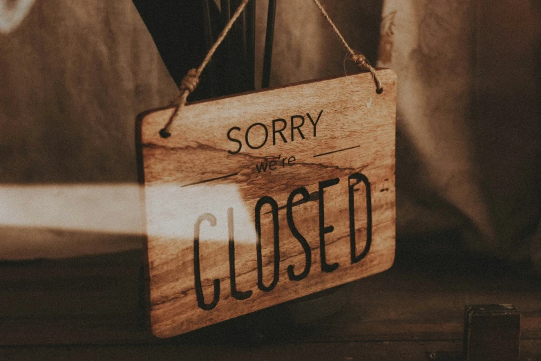 a wood sign that reads sorry and closed