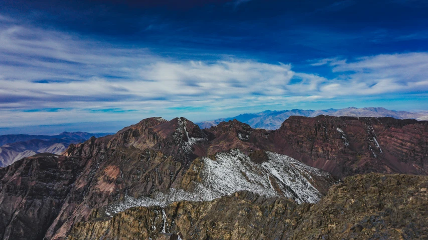 snow - covered mountains rise above a blue sky