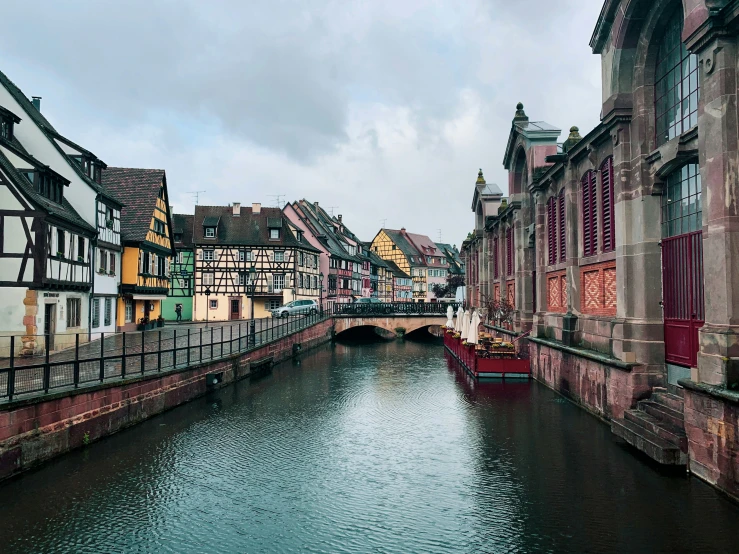 river with colorful buildings on both sides, in europe