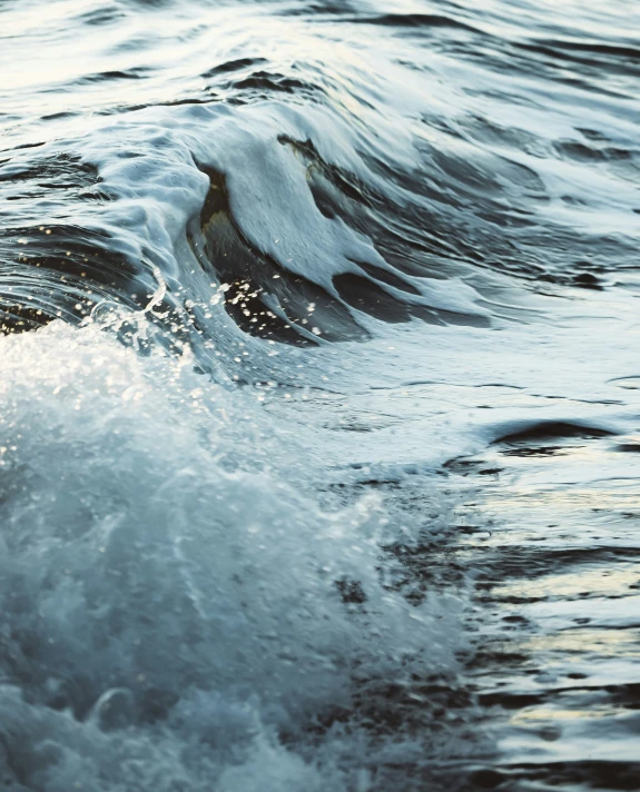 a wave breaking in to the ocean water