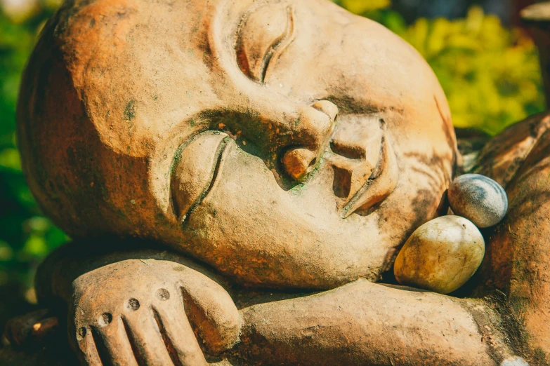 a small buddha statue in the middle of a garden