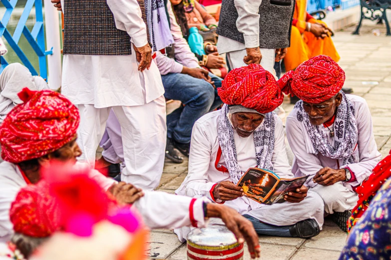 the men dressed in white and red are playing the music