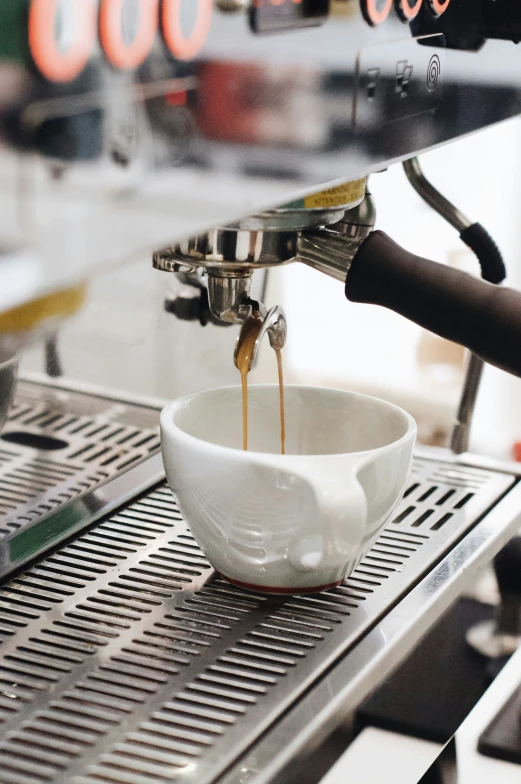 a person preparing coffee using a machine