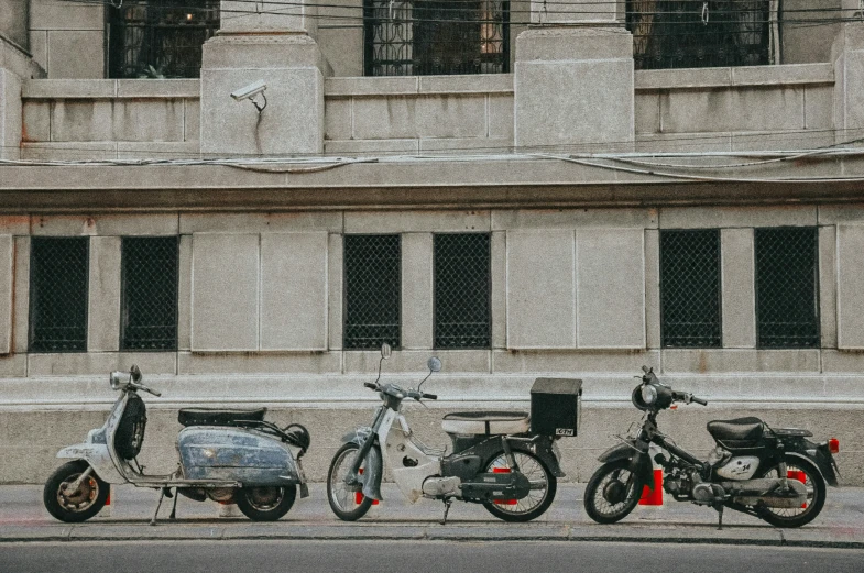 the scooters are parked outside of the building