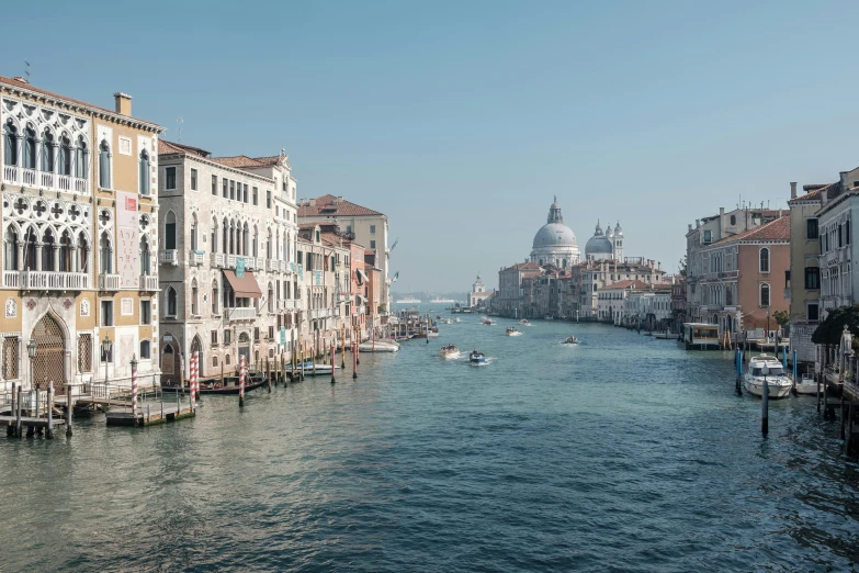 boats float down a large body of water in the city