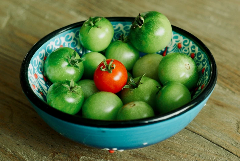 a bowl that has various fruits inside of it