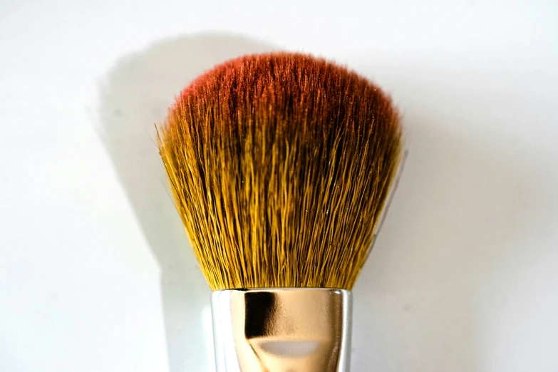 an open brush sitting on top of a white surface