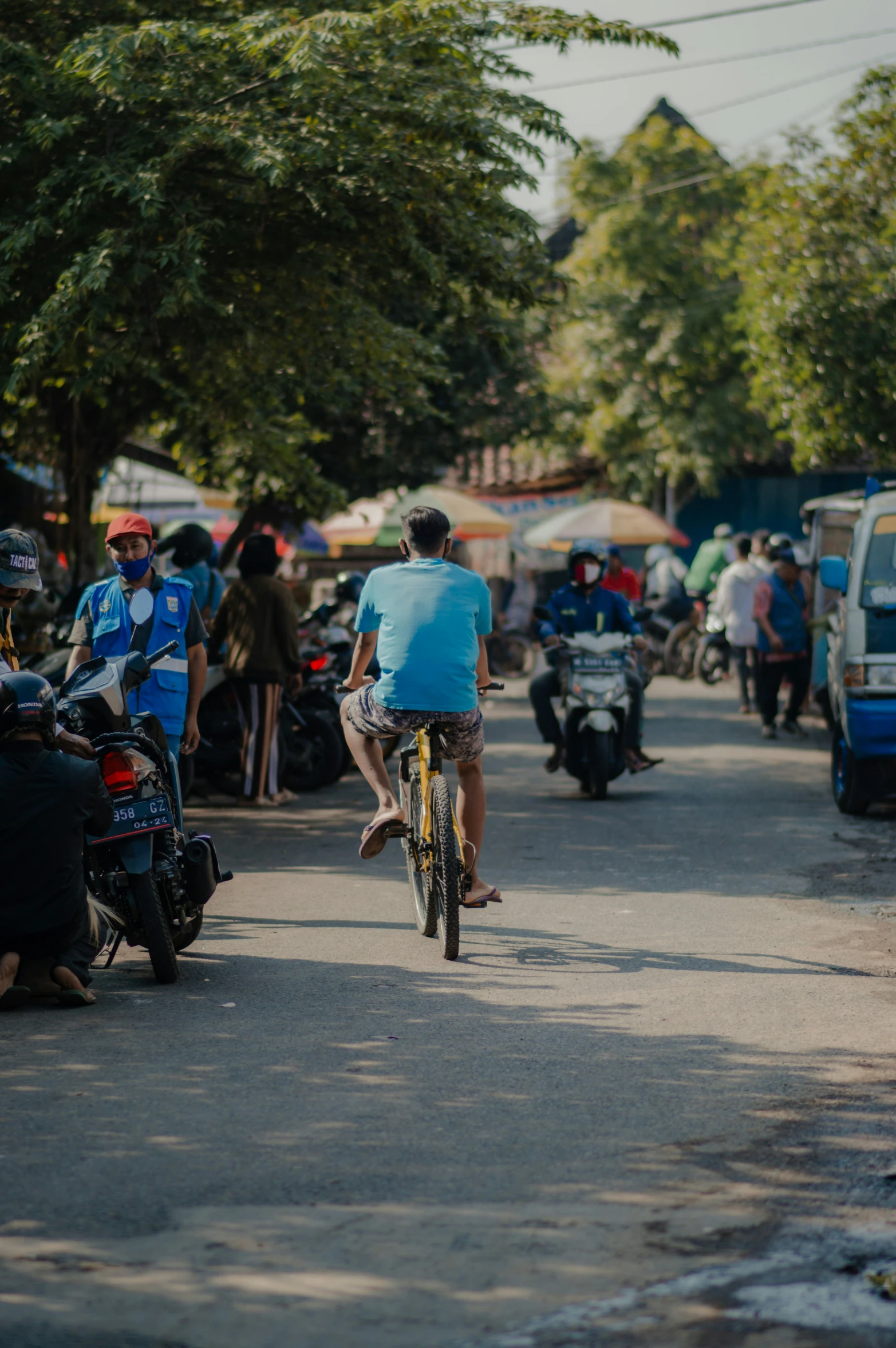 an image of people on bicycles riding down the street