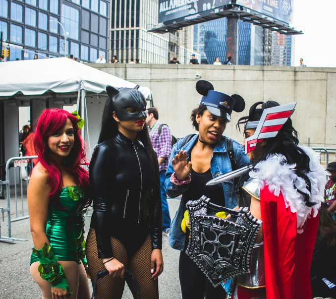 four people dressed up in costumes on a street