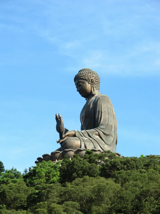 a large statue that is in the middle of some bushes