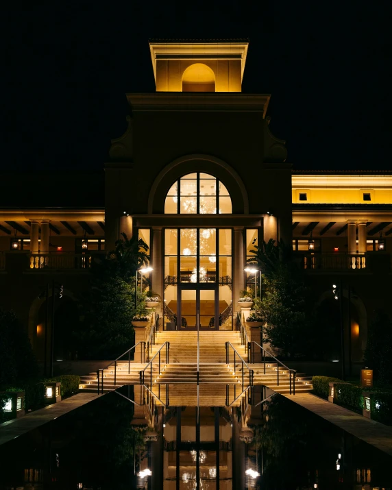 the building is lit up with lights from streetlights