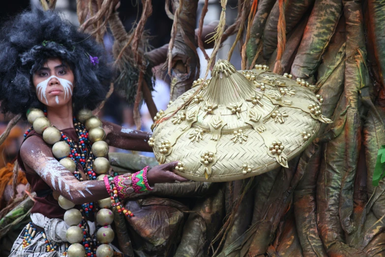 a person with a hair moustache is carrying some gold decorations