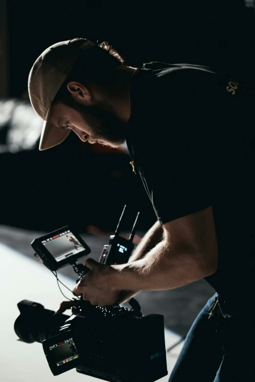 a man with a camera in his hands on a film set