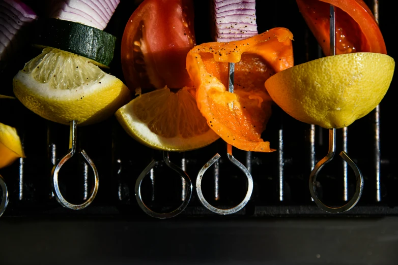 there are several sliced vegetables on a silver rack