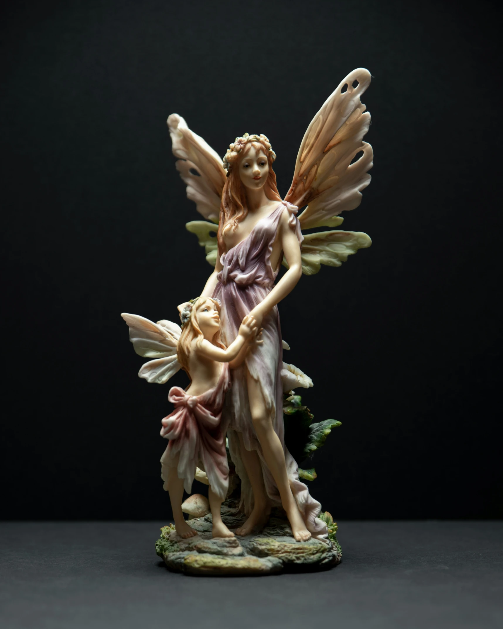 the statue depicts an angel with a child
