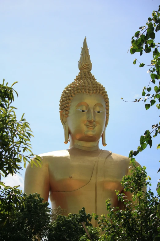 there is a large golden statue outside in the day