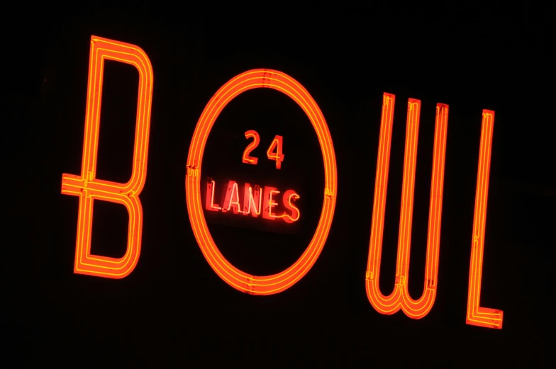 neon lights are on a building that says bowl