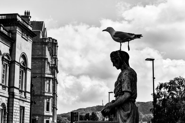 a woman with a bird on her head is standing near a building