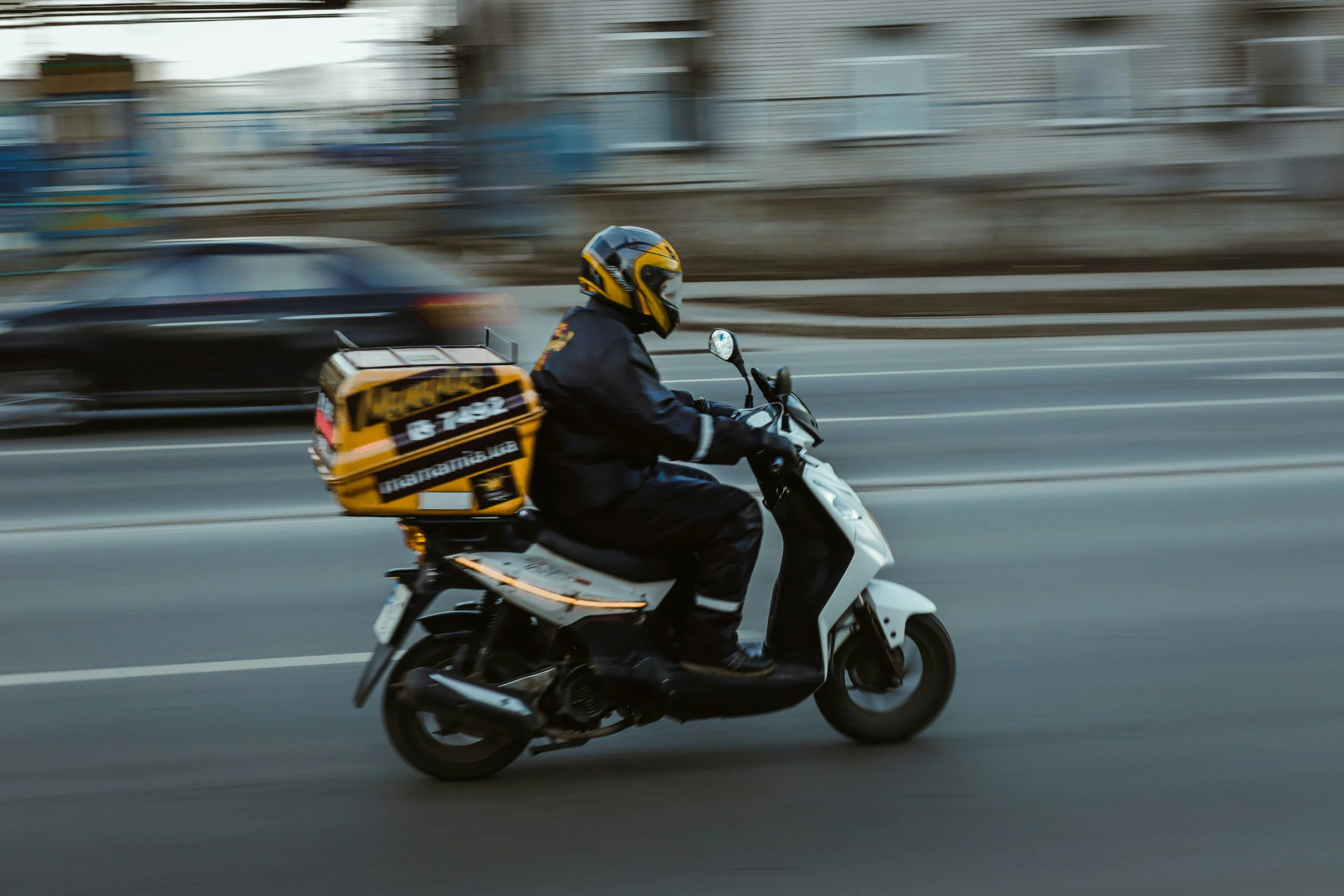 a person riding a motorcycle down a street