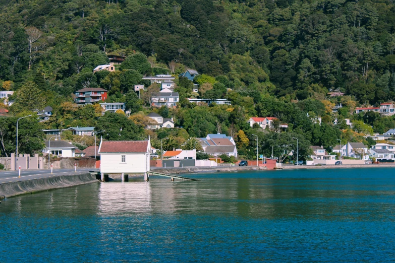 a boat on water near a city with hills