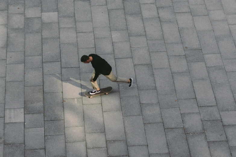 a man that is standing on a skateboard