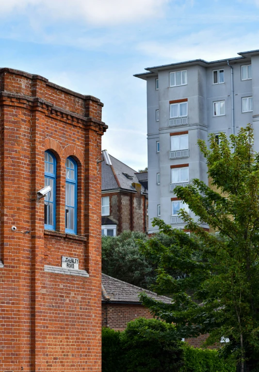 the clock is built on a red brick tower