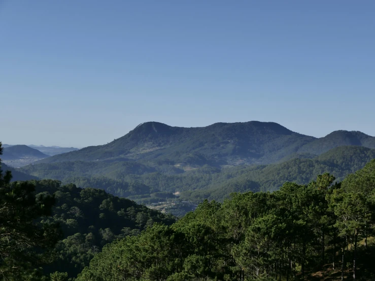 mountains and trees, in a valley surrounded by greenery