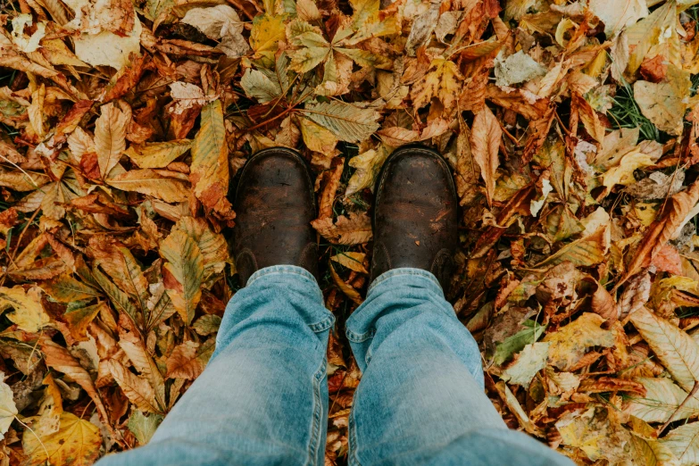 the person is standing in leaves with one foot up