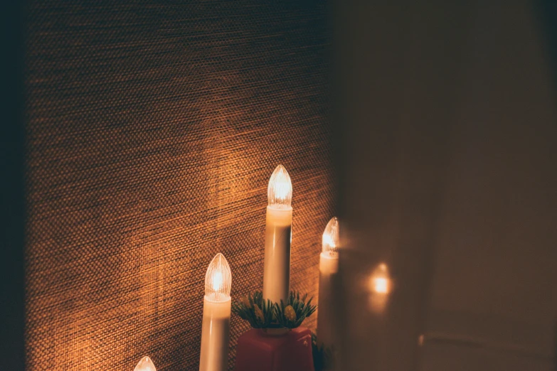 there are four candle lights on this table