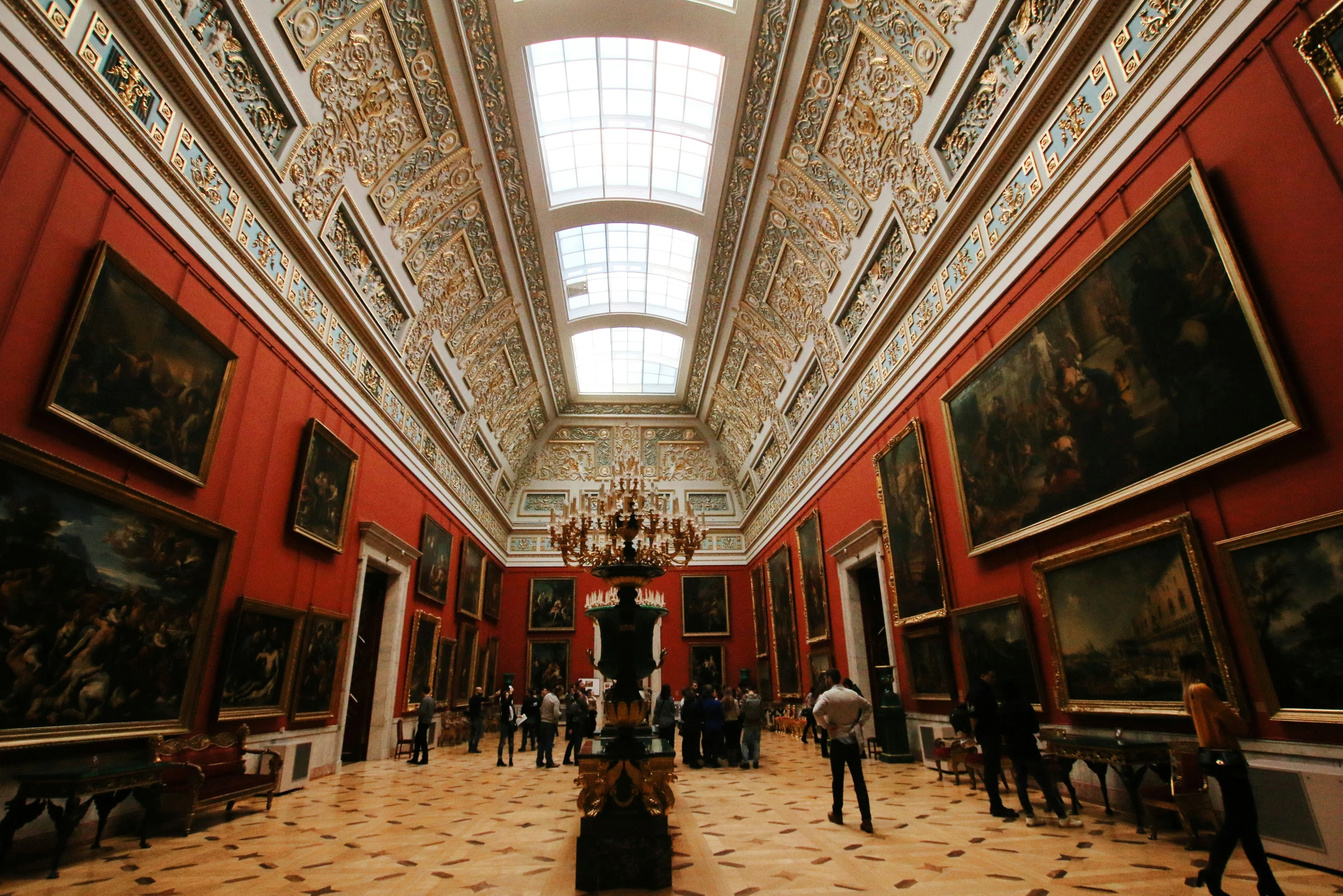 an ornate lobby with many paintings in a museum