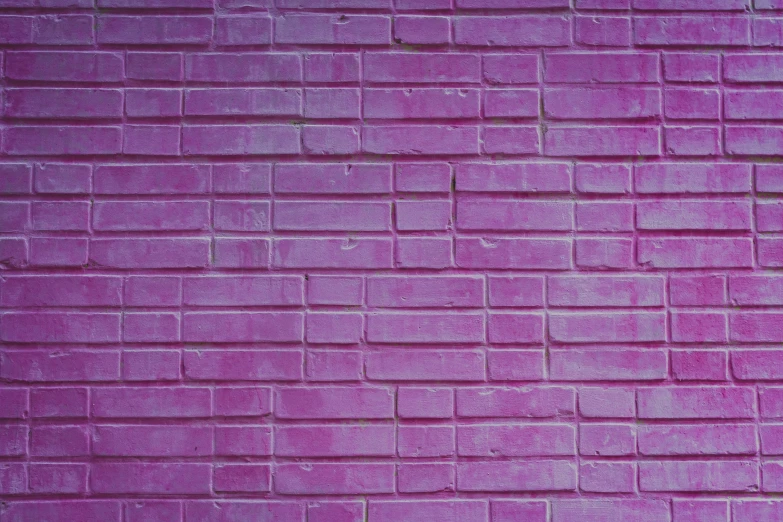 a purple brick wall in front of a building