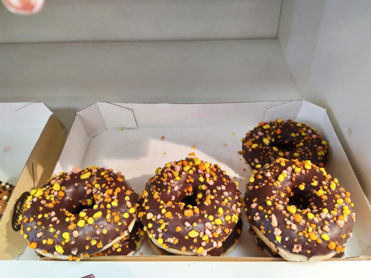 a box that has four donuts in it