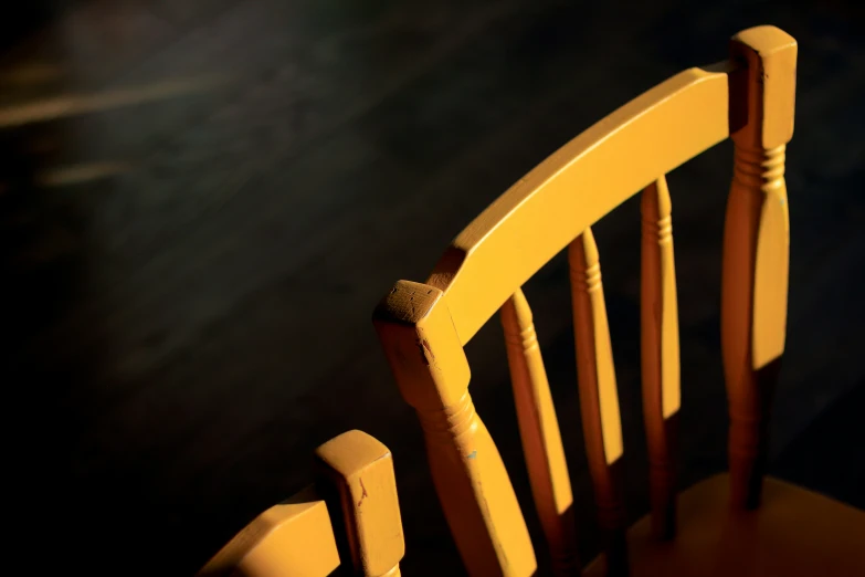 the back and arms of a wooden rocking chair