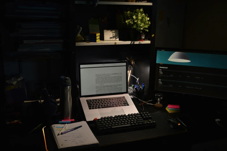 a laptop and some kind of writing on a desk