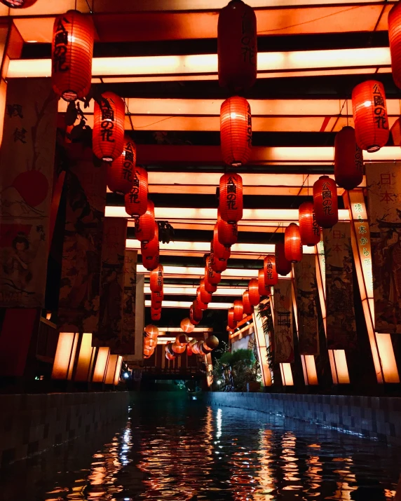 red lanterns hanging from the ceiling in a hallway