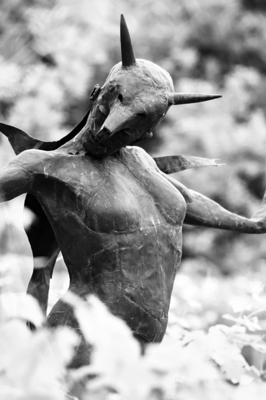 black and white image of a statue with horns