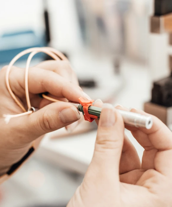 someone holding a pen in their hand as they use the device