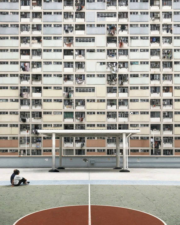 a basketball court in front of a tall building